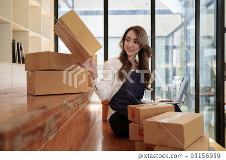Attractive Asian SME business woman working at home office. online shopping concept Attractive Asian SME business woman working at home office. online shopping concept 93156959