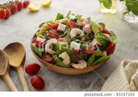 Fresh sea food salad with green mix, cherry tomatoes, herbs and olive oil, lemon dressing. Healthy food 93157103