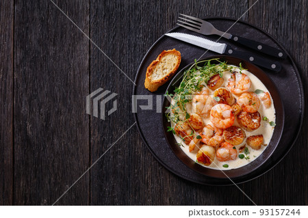 shrimps and scallops in spicy coconut cream sauce shrimps and scallops in spicy coconut cream sauce 93157244