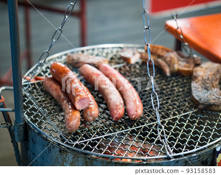 Grilled sausages on the grill net 93158583