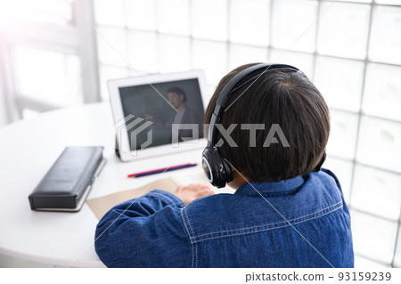 A boy taking an online class on a tablet Faceless lower grades A boy taking an online class on a tablet Faceless lower grades 93159239