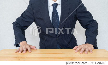 Businessman image that gets angry by hitting his hand on the desk Businessman image that gets angry by hitting his hand on the desk 93159606