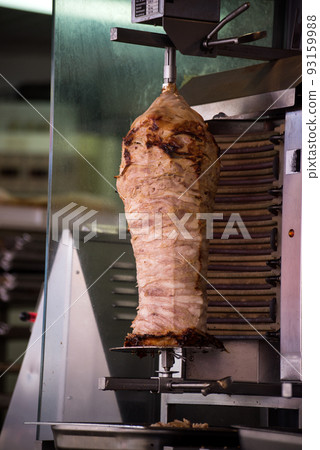 Closeup of roasted doner kebab at the fast food restaurant in the street Closeup of roasted doner kebab at the fast food restaurant in the street 93159988
