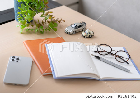 A notebook, pen and glasses on the desk 93161402