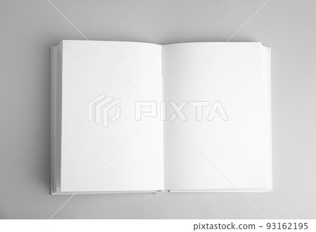 Open book with blank pages on grey background, top view 93162195