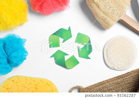 Recycling symbol, plastic and natural shower sponges on white background, top view 93162287