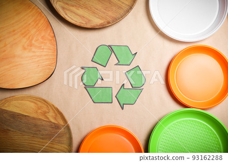 Recycling symbol, plastic and wooden plates on beige background, flat lay Recycling symbol, plastic and wooden plates on beige background, flat lay 93162288