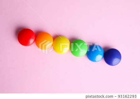 Bright magnets on pink background, flat lay. Rainbow colors Bright magnets on pink background, flat lay. Rainbow colors 93162293