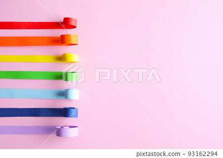 Bright paper strips and space for text on pink background, flat lay. Rainbow colors 93162294