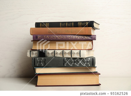Collection of different books on table against white wooden background 93162526
