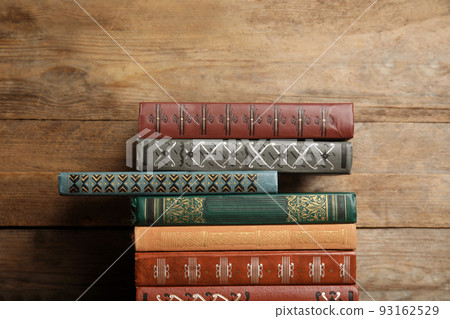 Collection of different books on wooden background 93162529