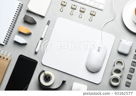 Flat lay composition with wired computer mouse and stationery on light grey table Flat lay composition with wired computer mouse and stationery on light grey table 93162577