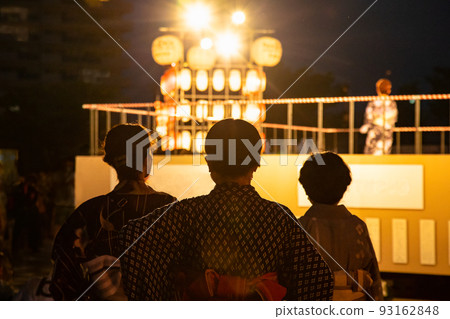 It is a snap scenery of Bon dance "Hiroshima Bon dance". A singer is singing on stage. Please use it as a background image of Obon. 93162848