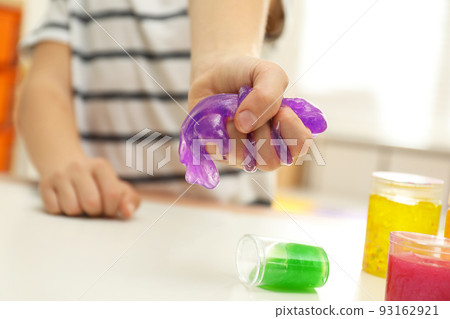 Little boy playing with slime at table indoors, closeup 93162921