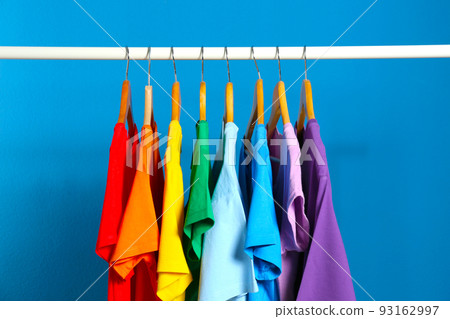 Bright clothes on blue background. Rainbow colors Bright clothes on blue background. Rainbow colors 93162997