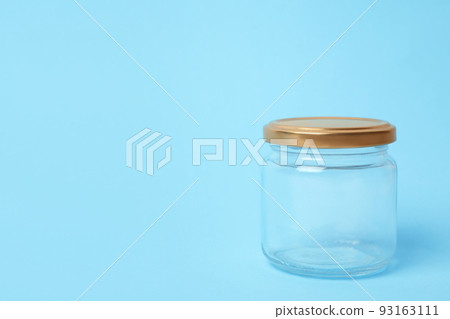 Closed empty glass jar on light blue background, space for text Closed empty glass jar on light blue background, space for text 93163111