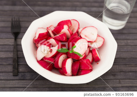 cooked crispy radish in white bowl on wooden table cooked crispy radish in white bowl on wooden table 93163696
