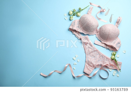 Flat lay composition with women's underwear on light blue background. Space for text Flat lay composition with women's underwear on light blue background. Space for text 93163789