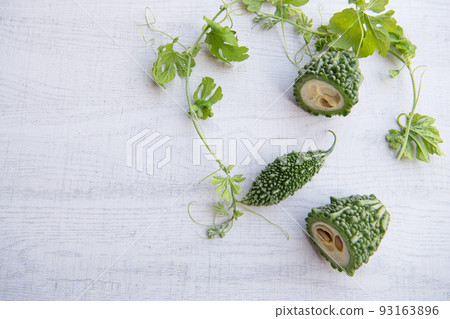 Bitter gourd or bitter melon with vine isolated on white wooden background. 93163896