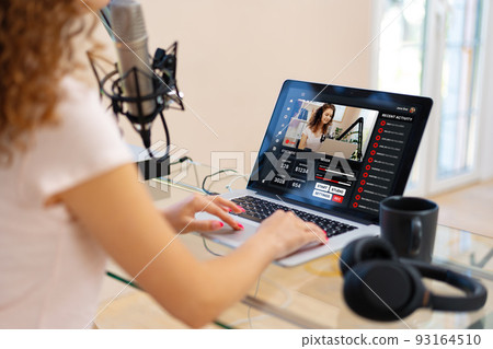 Close up of a woman recording a podcast in a studio 93164510
