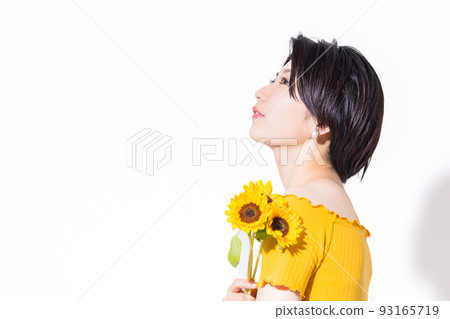 Beauty image Portrait of a woman holding a sunflower 93165719