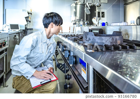 Male staff checking commercial kitchen equipment Commercial gas stove 93166780