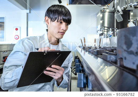 Male staff checking commercial kitchen equipment Commercial gas stove 93166782