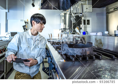 Male staff checking commercial kitchen equipment Commercial gas stove 93166785