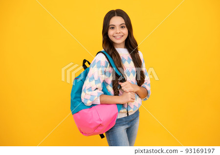 Back to school. Teenage school girl ready to learn. School children on yellow isolated background. 93169197