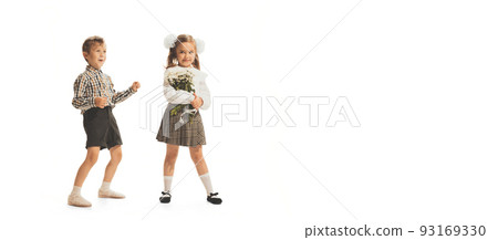 Portrait of children, boy in checkered shirt and girl with flowers posing isolated over white studio background 93169330