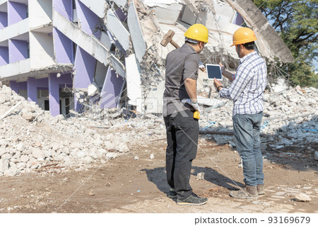 Engineer architect and worker operation control demolish old building. 93169679