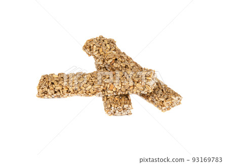 Three sweet sticks of sunflower gozinak from sunflower seeds and molasses on a white background. 93169783