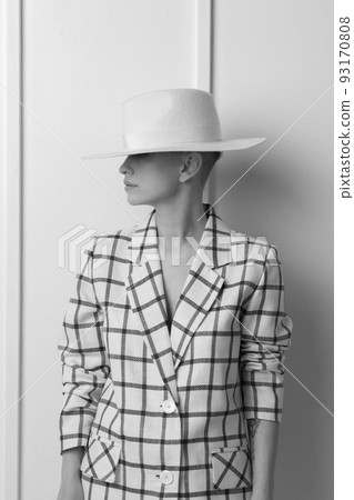 Elegant ant charismatic blond and short haired women with beautiful wide smile wearing oversized linen suit posing isolated in studio. Black and white version 93170808