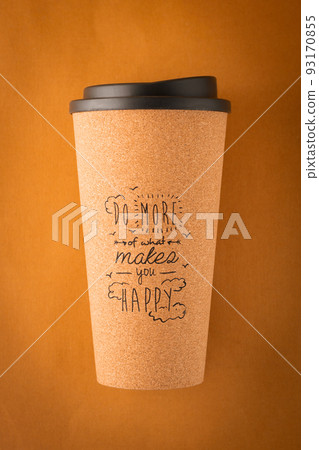A takeaway coffee cup made of cork wood with a positive inscription on a brown background A takeaway coffee cup made of cork wood with a positive inscription on a brown background 93170855
