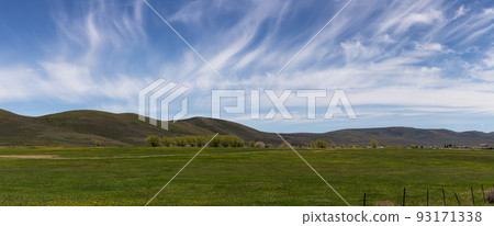 Cloudscape over the green fields in a city during sunny day. 93171338