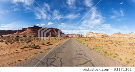 Scenic Road in the Dry Desert with Red Rocky Mountains in Background. 93171391