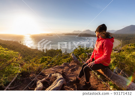 Adventurous Woman Hiker overlooking Sandy Beach on the West Coast of Pacific Ocean Adventurous Woman Hiker overlooking Sandy Beach on the West Coast of Pacific Ocean 93171432