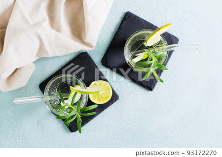 Detox drink water with lime and rosemary in glasses with eco straw on the table. Top view 93172270