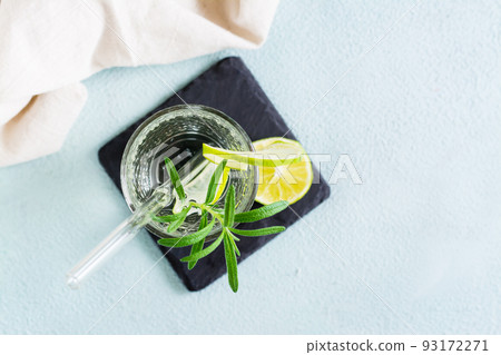 Refreshing drink mineral water with lime and rosemary in glasses with eco straw. Top view. Close-up 93172271