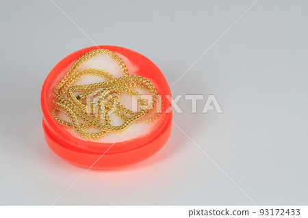 A keel pattern gold necklace in the chinese style red box isolated on white background. A keel pattern gold necklace in the chinese style red box isolated on white background. 93172433