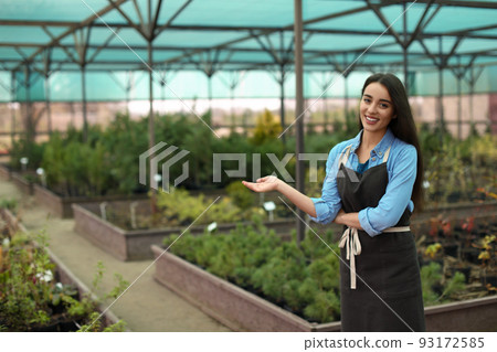 Female business owner showing her greenhouse. Space for text 93172585