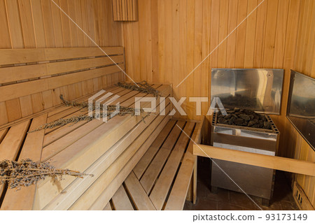 Interior of a sauna in a private house with an electric boiler 93173149