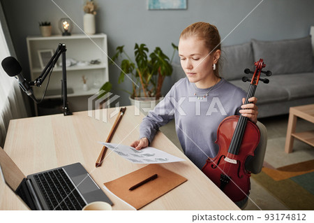 Young Woman Playing Violin at Home Studio Young Woman Playing Violin at Home Studio 93174812