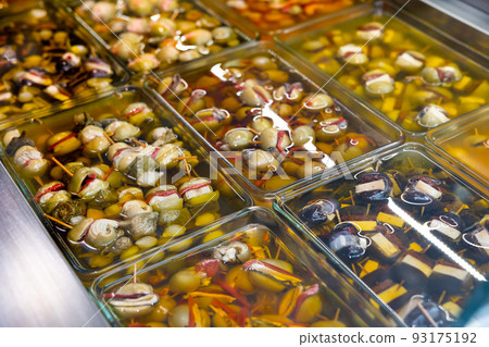 Pickled stuffed olives in glass containers on market counter Pickled stuffed olives in glass containers on market counter 93175192
