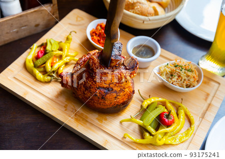 Schweinsstelze on wooden serving board Schweinsstelze on wooden serving board 93175241