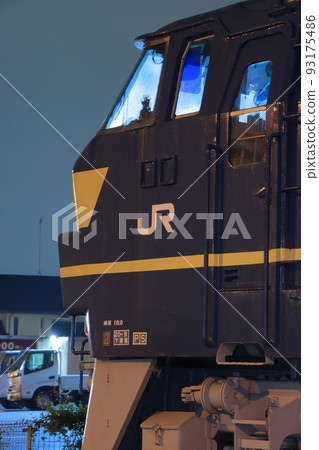 A preserved EF66 locomotive that looks like it is in service under the light of the streetlights. A preserved EF66 locomotive that looks like it is in service under the light of the streetlights. 93175486