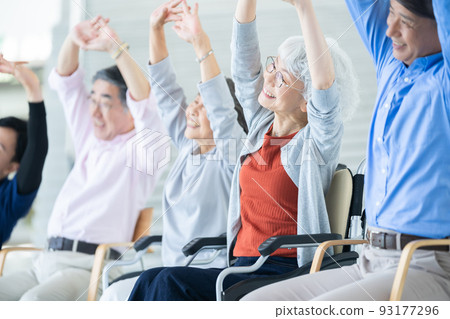 Elderly housing with care users doing gymnastics Senior image Caregiver 93177296