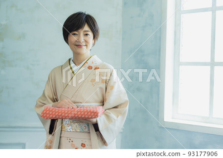 A woman in a beige visiting dress Furoshiki 93177906