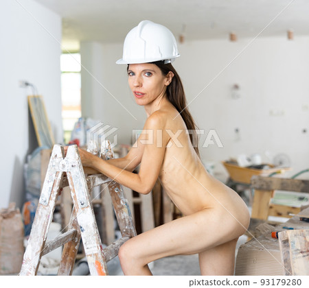 Nude young adult woman posing near ladder 93179280