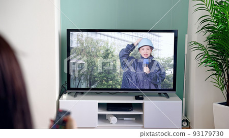 Female news program watching disaster broadcast 93179730